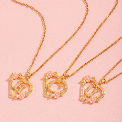 Collana con iniziale e charm floreale | Oro