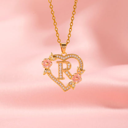 Collana con iniziale e charm floreale | Oro