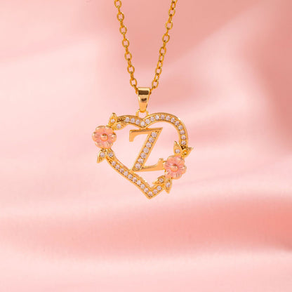 Collana con iniziale e charm floreale | Oro